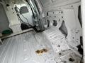 Interior of a 2008 Ford Econoline van showing an empty cargo space with bare metal flooring and some dirt marks