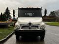 A 2006 Hino 155 truck with a white exterior and chrome grille visible from the front perspective