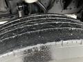 Close-up of a textured tire tread on a 2013 Ford F-650 with visible water droplets on the surface