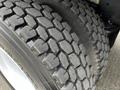 Close-up of a tire from a 2006 Freightliner M2 112 showcasing deep treads designed for traction and durability