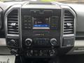Dashboard of a 2017 Ford F-150 featuring a central display screen and control buttons for audio and climate settings
