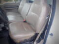 Interior of a 2008 Ford F-550 showing two beige leather front seats without any occupants