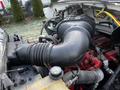 Engine compartment of a 2011 Ford F-750 showing the air intake and various hoses and components in a close-up view