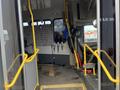 Interior of a 2012 Chevrolet Express showing the driver's seat and seating area with safety straps and a yellow handrail