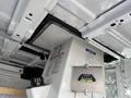 2008 Ford Econoline interior showing equipment, including a grey control box with a pressure gauge and safety instructions mounted to the van's ceiling