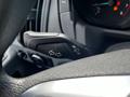 A close-up of the multifunction lever on the steering column of a 2018 Ford Transit indicating turn signals and light controls