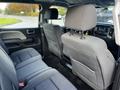 Interior view of a 2017 GMC Sierra 1500 with spacious back seats and a modern dashboard design