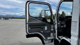 A 2018 Mitsubishi Fuso FE with the driver's door open revealing the interior dashboard and seat