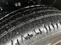 Close-up of a robust tire tread on a 2022 RAM 1500 Classic highlighting deep grooves and a shiny surface