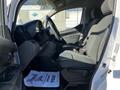 Interior of a 2017 Nissan NV200 featuring two front seats and a steering wheel with a dashboard visible