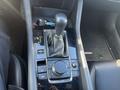 The center console of a 2023 Mazda MAZDA3 featuring the gear shifter control knob and buttons for various functions