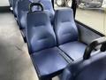 Two blue fabric seats in a row designed for passenger seating in a vehicle