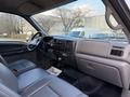 Interior view of a 2006 Ford F-650 showing the dashboard steering wheel and seats with gray upholstery and various controls