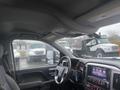 Interior view of a 2015 GMC Sierra 1500 showing the dashboard and central control panel with various buttons and a touchscreen display