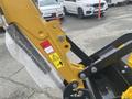 A close-up of a 2024 AGT Industrial H13R Mini Excavator's arm showing its hydraulic components and safety labels