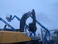 A yellow John Deere 350G excavator with a large bucket attachment is positioned in the foreground, showcasing its articulated arm and heavy-duty construction features