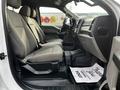 Interior of a 2021 Ford F-550 with gray upholstery and spacious seating showing two front seats and a dashboard view