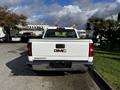 A white 2017 GMC Sierra 1500 truck viewed from the rear showcasing its tailgate with the GMC logo and Sierra lettering