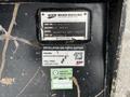 A close-up view of a Caterpillar 306 machine identification plate showing model number and specifications