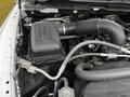 Close-up view of the engine compartment of a 2022 RAM 1500 Classic highlighting the air intake system and various engine components