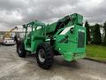A green 2014 JLG 10054 telehandler with large tires and a raised boom attached to the front