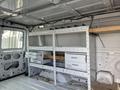 Interior of a 2008 Ford Econoline with shelving units and storage drawers installed