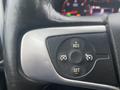 Close-up of a steering wheel control panel featuring buttons for resume plus set and cruise control adjustments