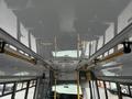 Interior view of a 2017 Chevrolet Express bus showing the ceiling and overhead grab rails