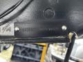 A metal identification plate attached to a trailer displaying the serial number 573FR3824M991029