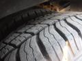 Close-up of a tire with deep tread patterns mounted on a 2016 Chevrolet Express showing wear and texture of the rubber surface