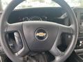 Steering wheel of a 2017 Chevrolet Express with the Chevrolet logo and control buttons on the left side