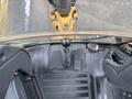 Interior view of a 2011 John Deere 310SJ 4x4 Wheel Loader Extended Hoe 4 in 1 showing the gear shift lever and operator controls