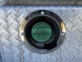 A green diesel fuel cap with the word DIESEL visible near a silver diamond-plate surface