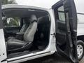 A 2019 Chevrolet Colorado with an open front door showcasing two front seats in gray upholstery and a spacious interior