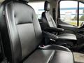 Two black leather seats of a 2020 Ford Transit with adjustable armrests