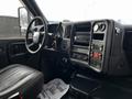 Interior of a 2006 GMC C5000 featuring a steering wheel dashboard controls and leather seat