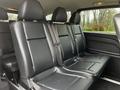 Interior view of the back seat of a 2018 Mercedes-Benz Metris showing three black leather seats with seatbelts