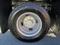 Close-up of a 2011 Ford F-350 SD tire mounted on a silver rim with the Goodyear Wrangler branding visible on the tire sidewall