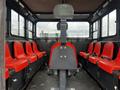 Interior of a 2023 Prinoth Panther T6 showcasing red seats arranged on either side with a central driver's seat and no visible occupants