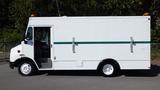 A white 2004 Freightliner MT45 delivery truck with a green stripe on the side and a walk-in cargo area visible through the open driver's door