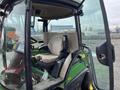 A 2014 John Deere 1585 Terrain Cut lawn mower with a green exterior and a beige seat visible in the driver's cabin