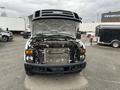 A 2010 Ford F-250 SD with the hood raised revealing the engine compartment and cooling system components