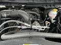 Close-up of the engine of a 2022 RAM 1500 Classic showing various components including hoses and an engine block