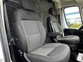 Two gray upholstered seats are positioned in the front cabin of a 2021 RAM Promaster van with adjustable headrests and armrests