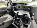 Interior view of a 2009 Ford Econoline van showing the dashboard and center console with a mounted device holder and cup holders