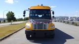 A yellow 2014 Freightliner Thomas Bus Diesel with a black front hood and blue light on top facing forward