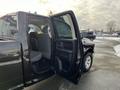 A 2015 RAM 1500 with its rear door open showcasing the interior seating and cabin space