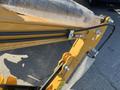 A close-up view of the hydraulic arm and components of a yellow 2024 AGT Mini Excavator with protective bubble wrap on the boom