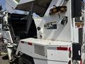 A white 2015 Global Street Sweeper with an open hood revealing its engine compartment and various warning labels visible on the body