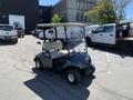 2019 Yamaha G29 E Electric G29 Golf Car with beige seating and a windshield parked on a paved surface